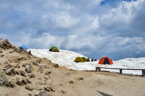 平日の正午。登山道横にテント場がある。